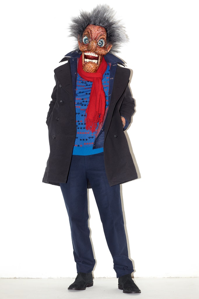 black coat blue sweater red scarf