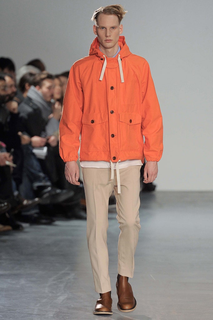orange hooded jacket with beige pants