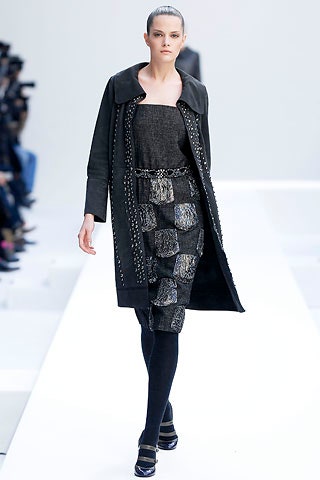 black fitted coat and pleated dress