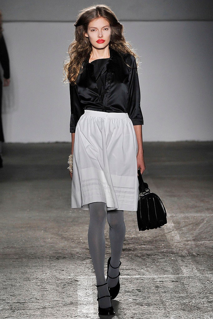black silk blouse and white pleated skirt