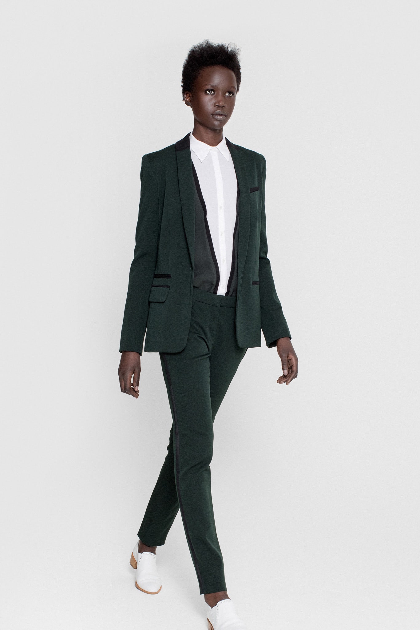 green tailored suit with white shirt