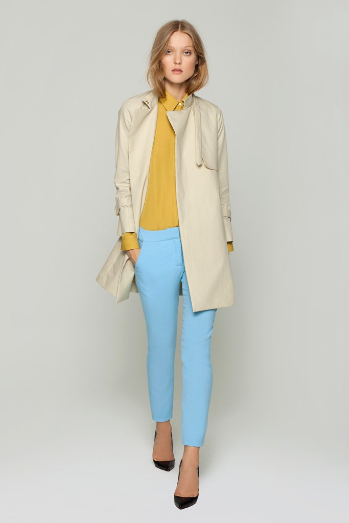beige trench coat with yellow blouse