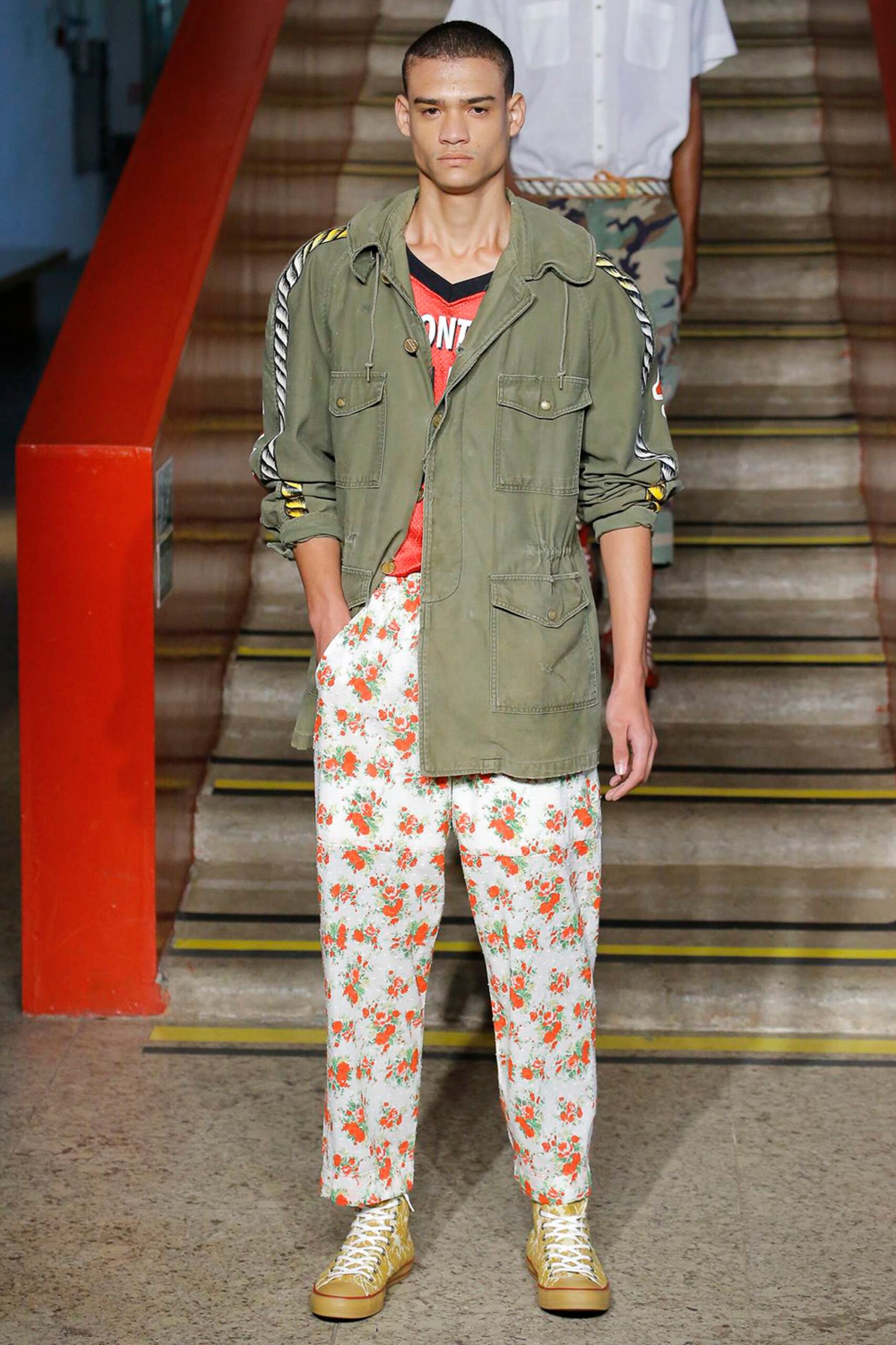green jacket red t-shirt floral pants