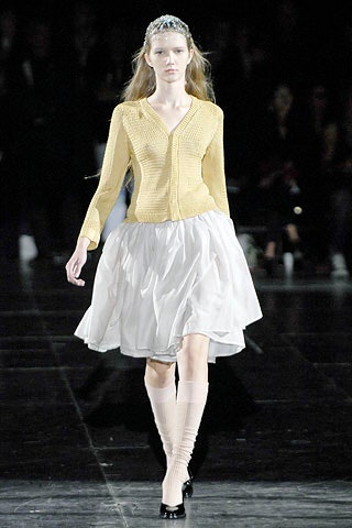 yellow cardigan and white pleated skirt