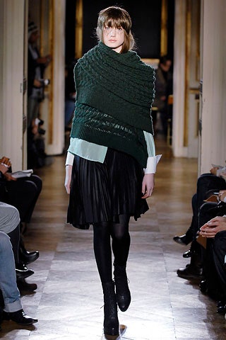 light blue top with black pleated skirt