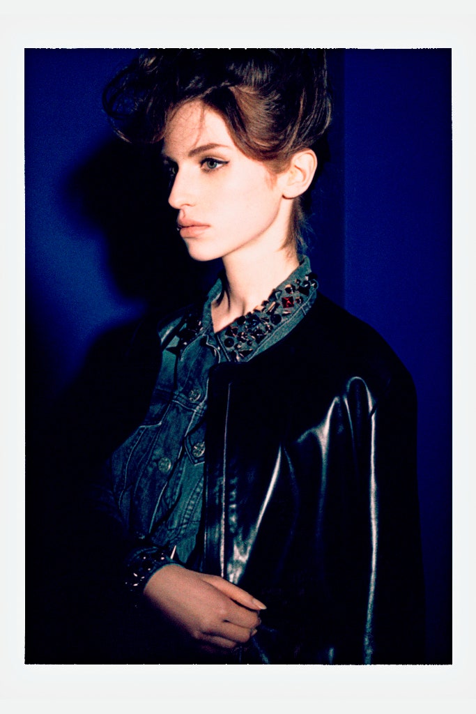 black leather fitted jacket and blue denim shirt
