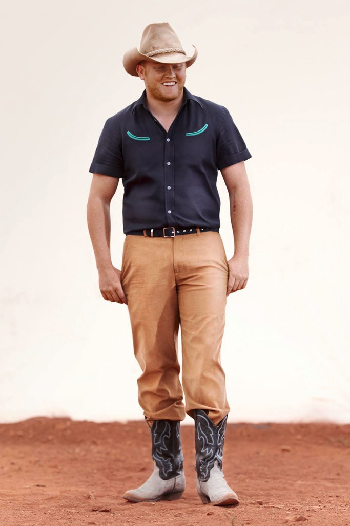 black shirt brown pants cowboy boots