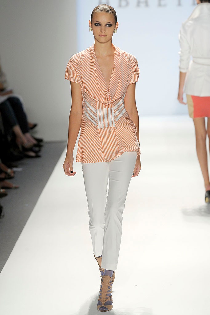 orange and white fitted top with slim pants