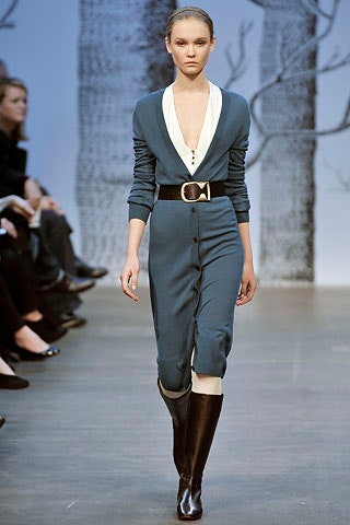 blue fitted jumpsuit with black boots