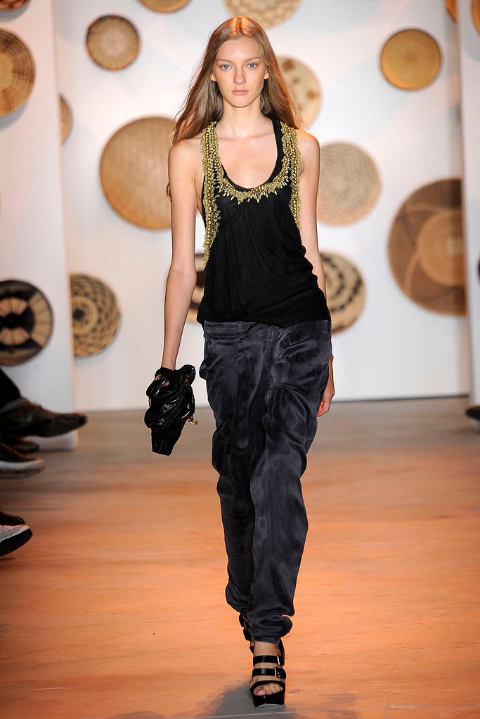 black embellished sleeveless top and gray relaxed pants