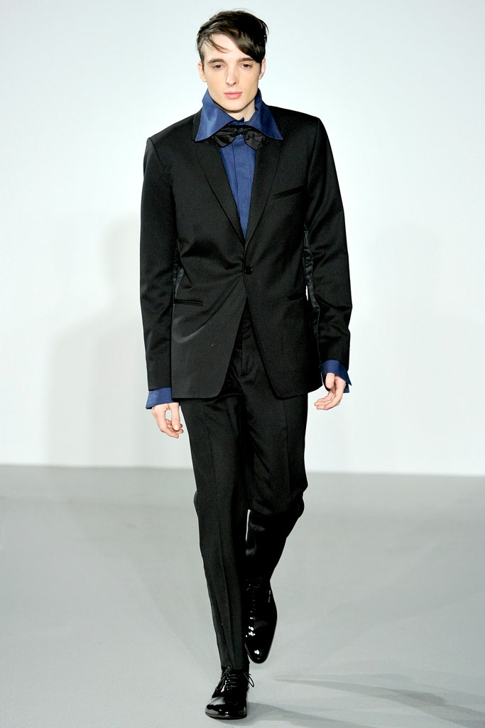 black tailored suit with blue shirt