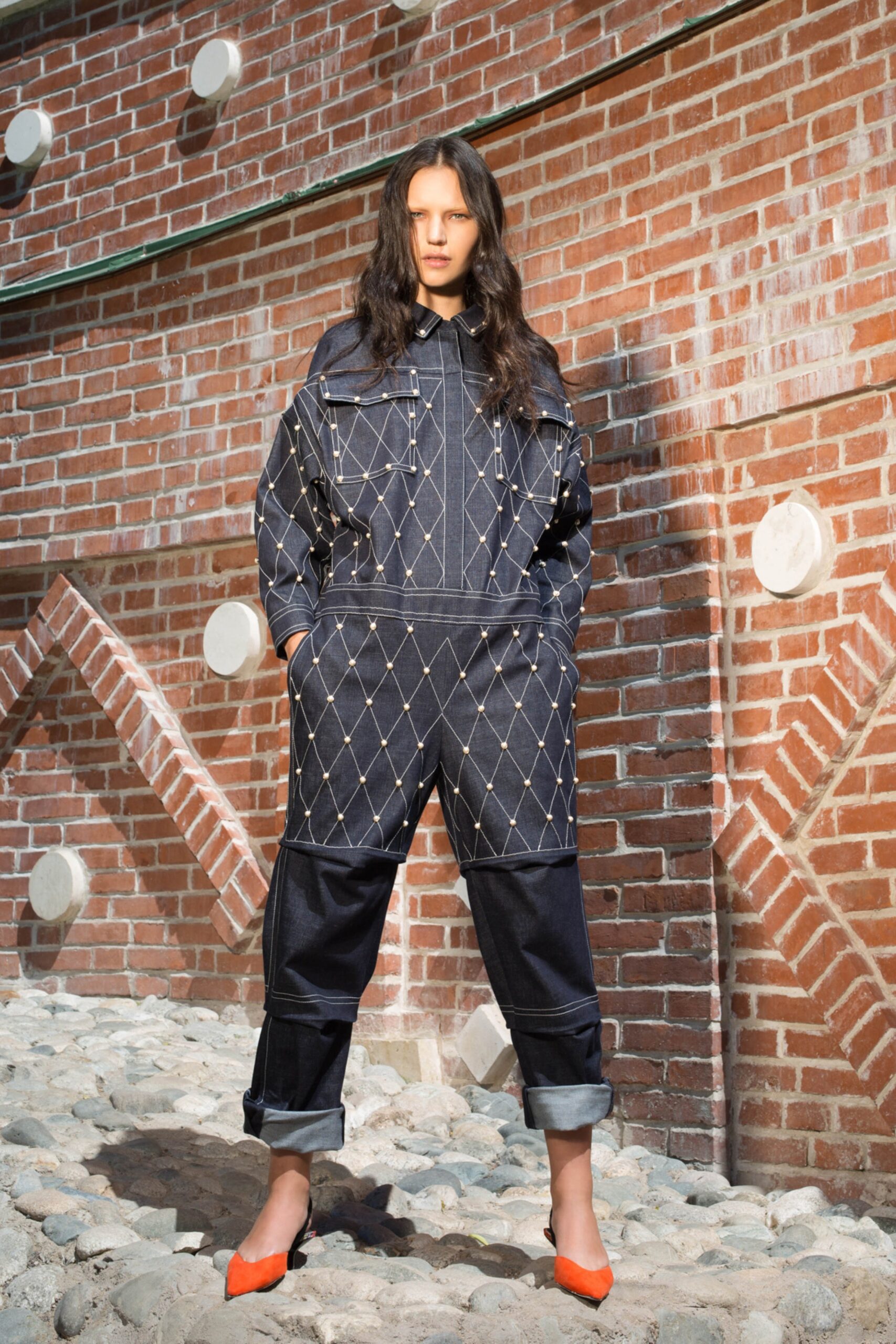 blue denim relaxed jumpsuit with orange shoes