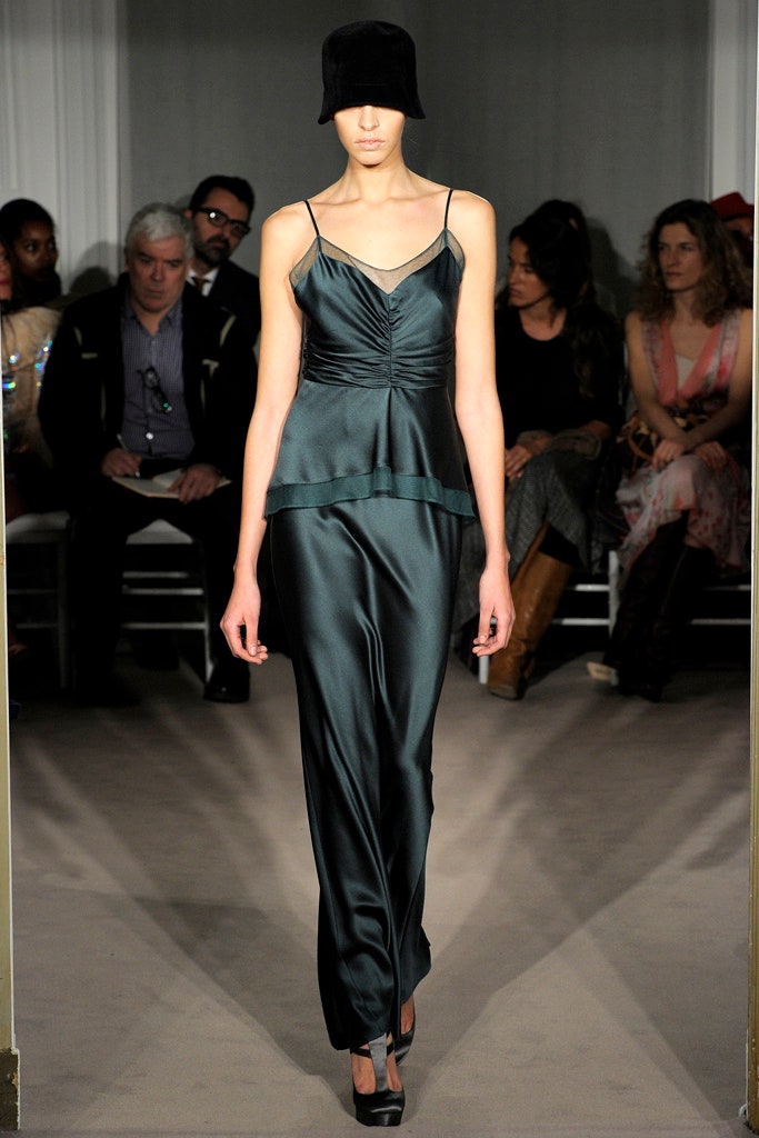 fitted green silk midi dress with black velvet hat