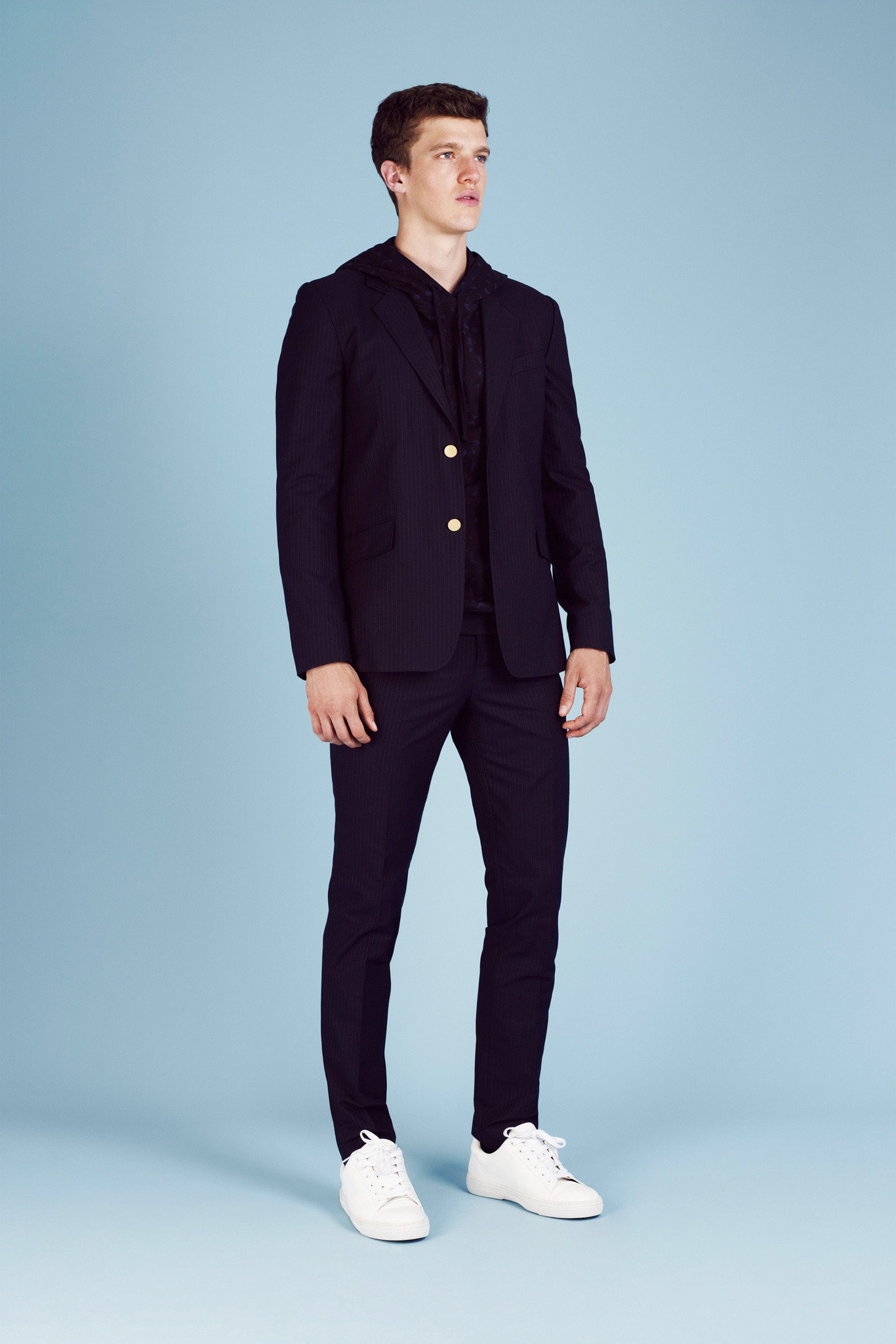 black tailored suit with white shoes