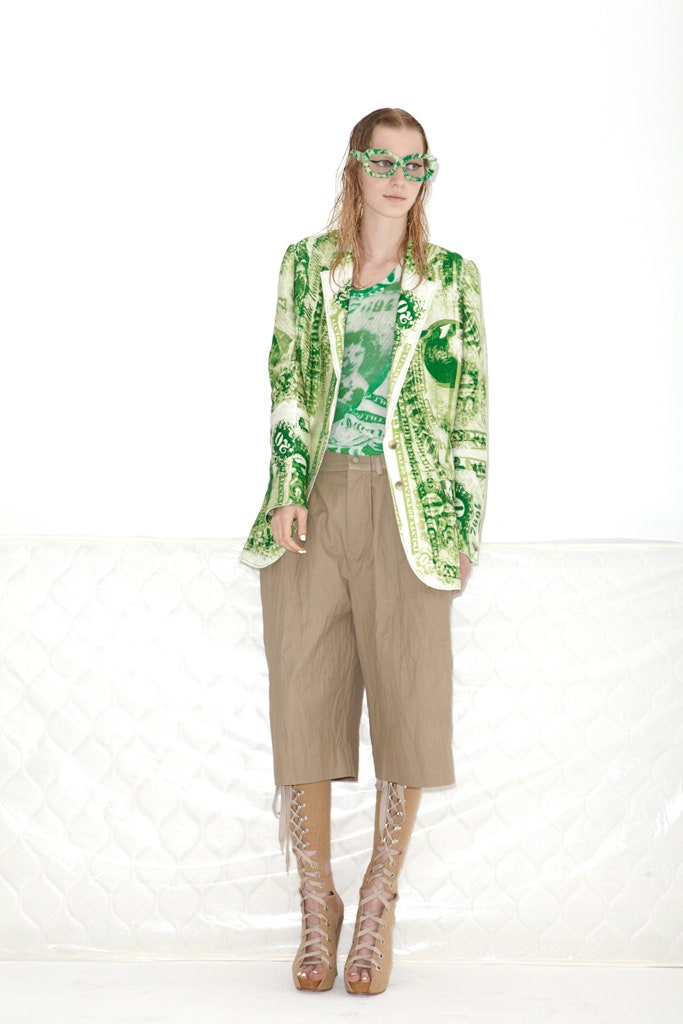 green printed blazer with beige pants