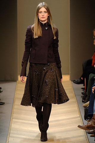 purple fitted jacket with brown pleated skirt