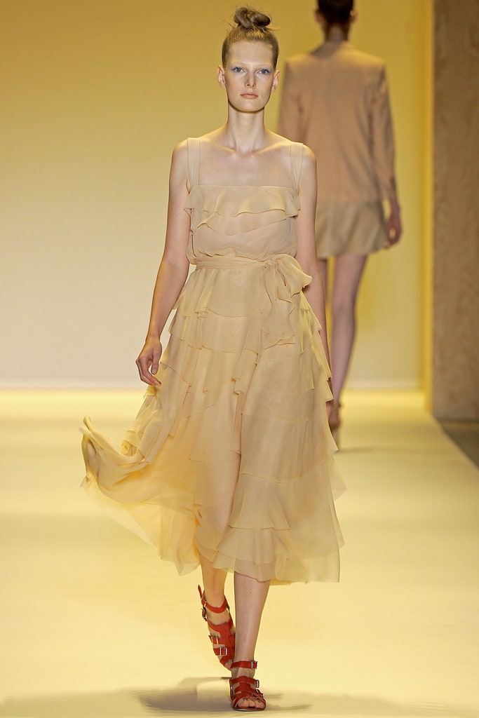 beige ruffled midi dress with red shoes