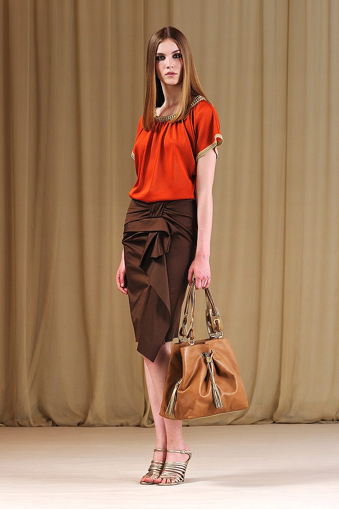 orange top and brown skirt