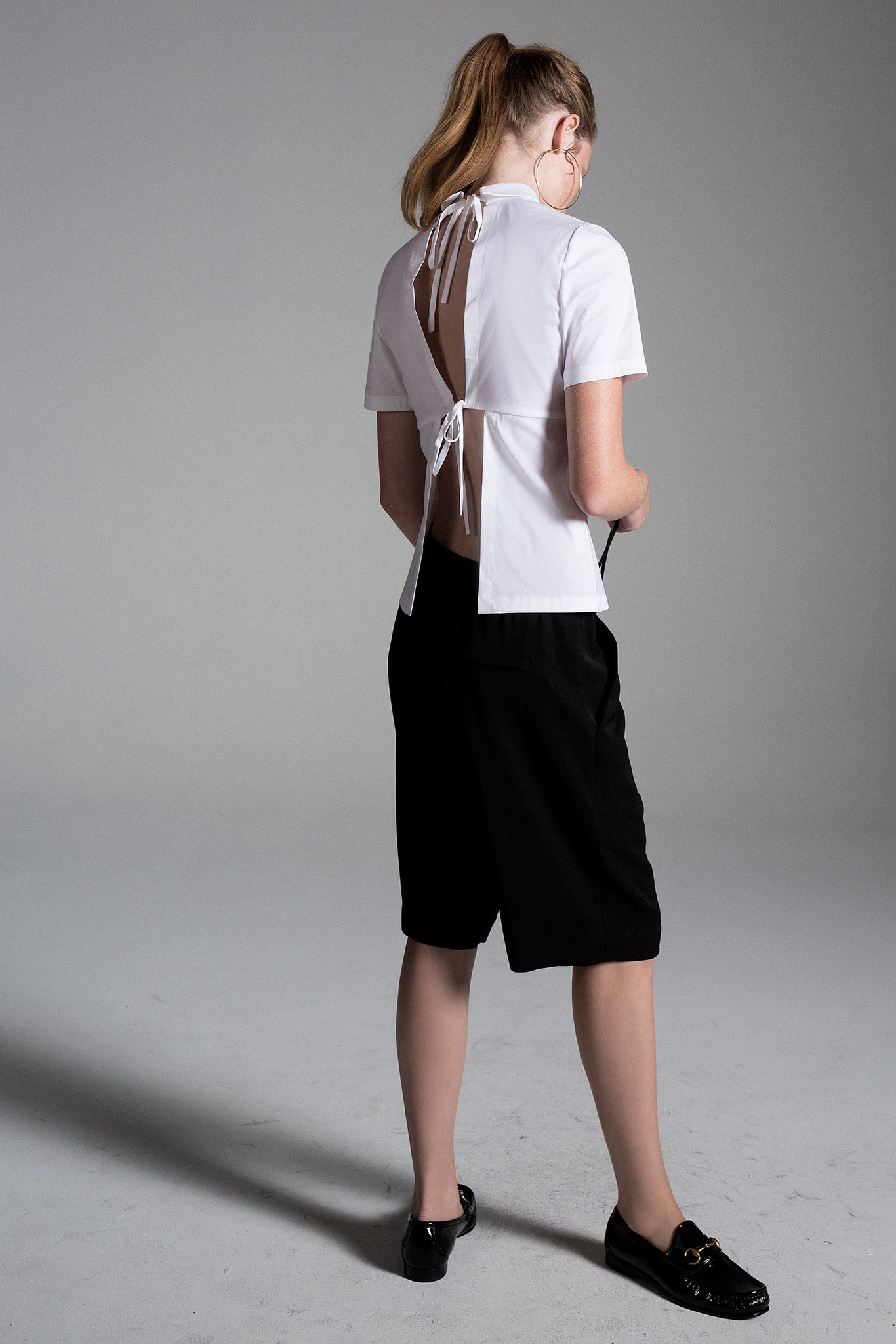 white fitted top with black shorts