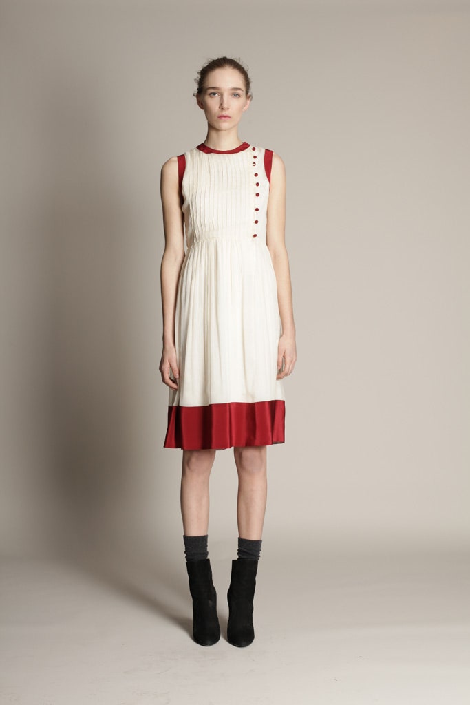 white cotton sleeveless v-neck fitted pleated buttoned dress