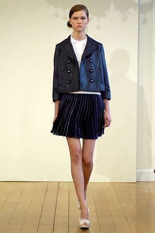 blue fitted jacket and navy pleated skirt