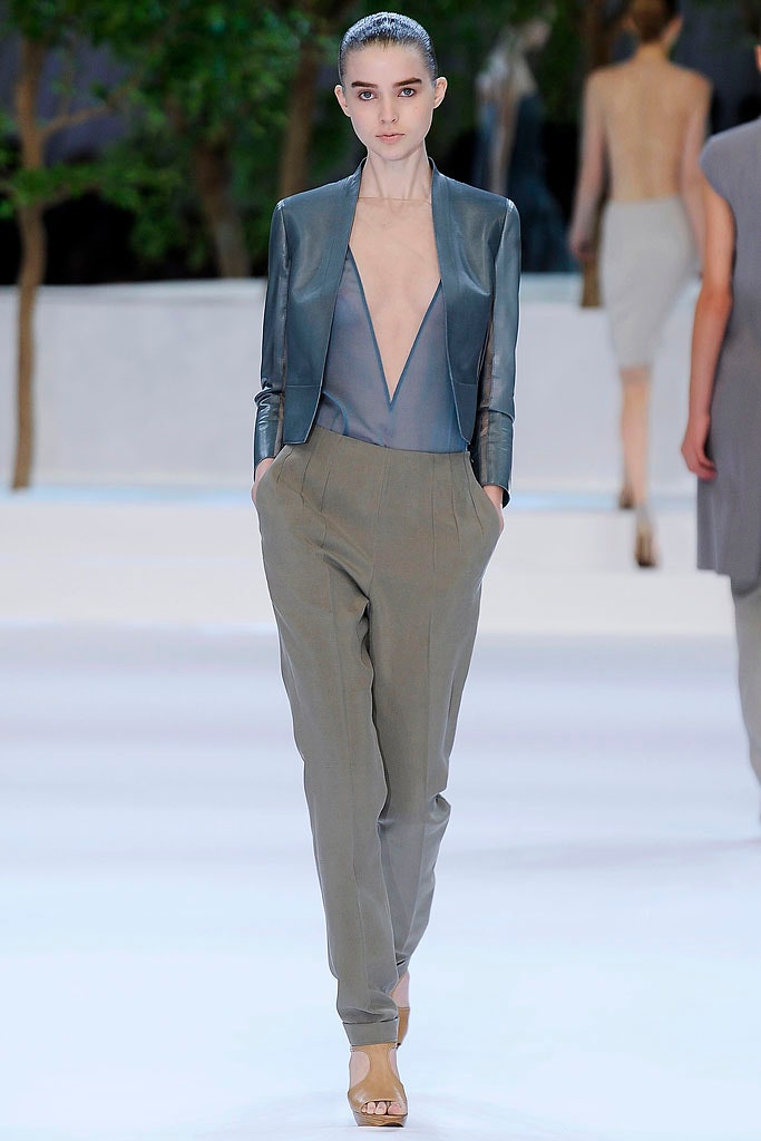 blue leather fitted jacket and gray relaxed pants