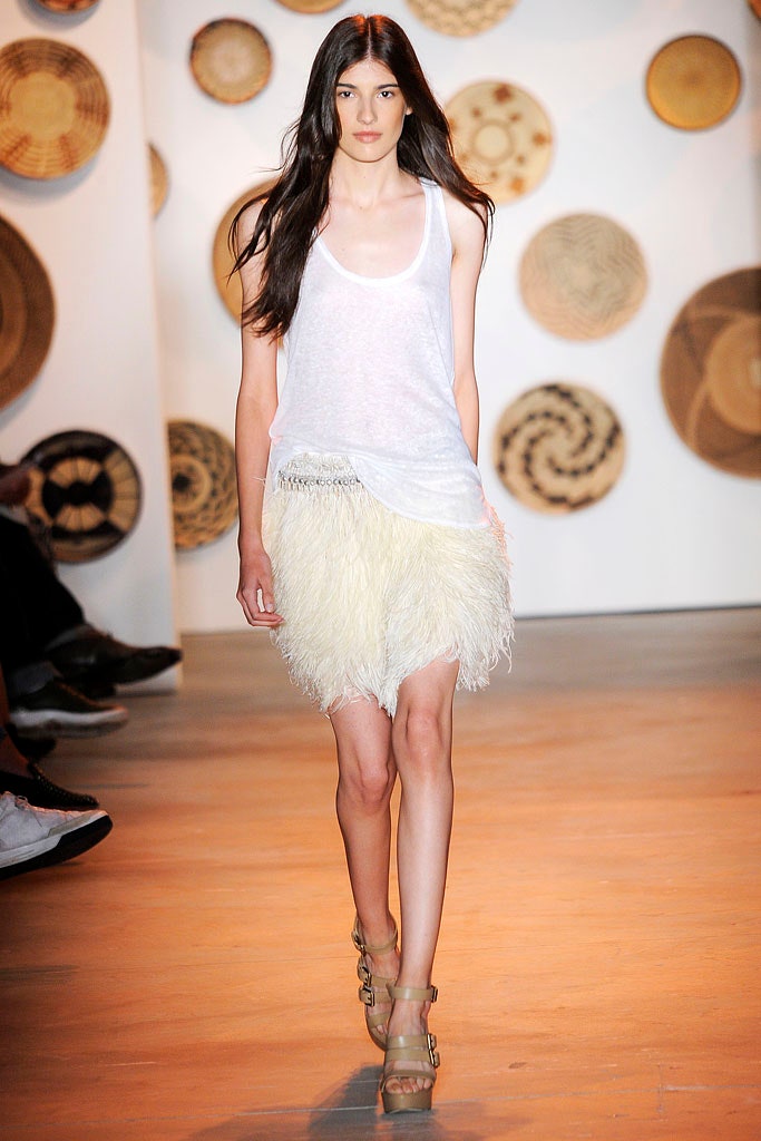 white fitted top with yellow feathered skirt