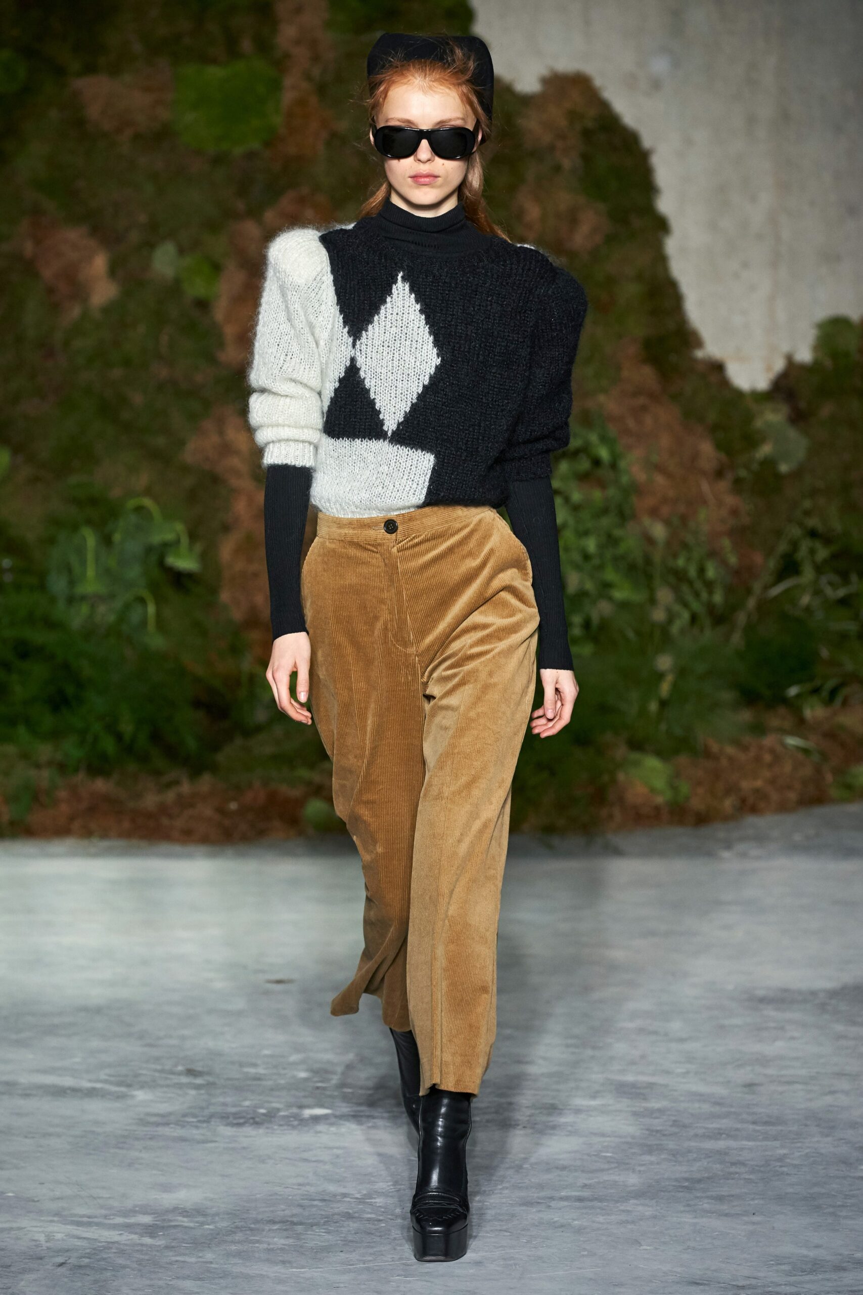 black and white sweater with brown pants