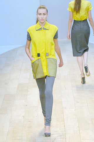 yellow relaxed coat with gray pants