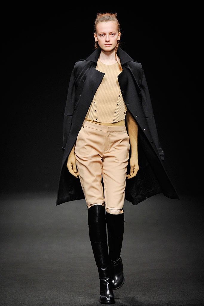 black coat beige top tailored pants