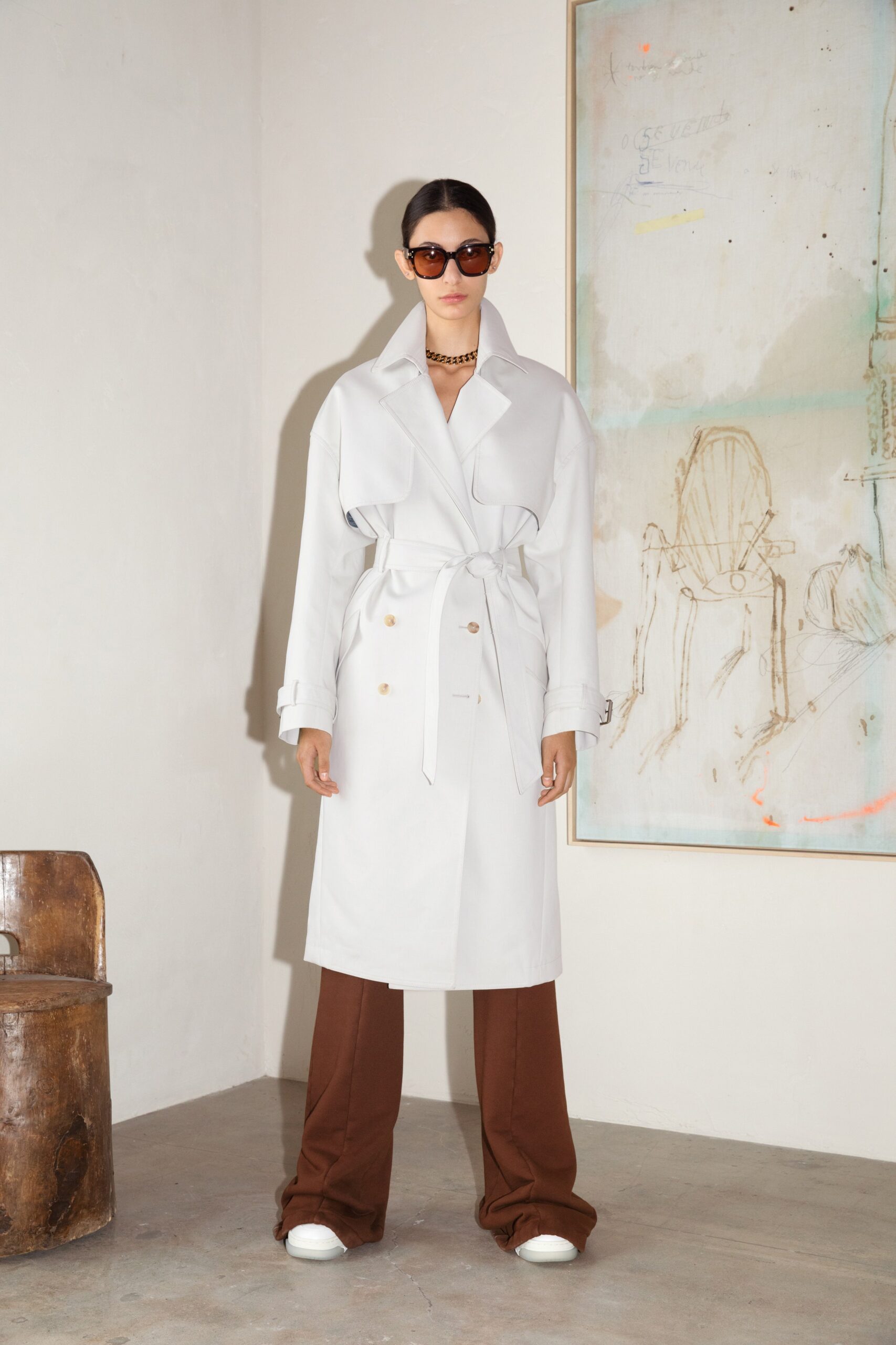 white trench coat with brown pants