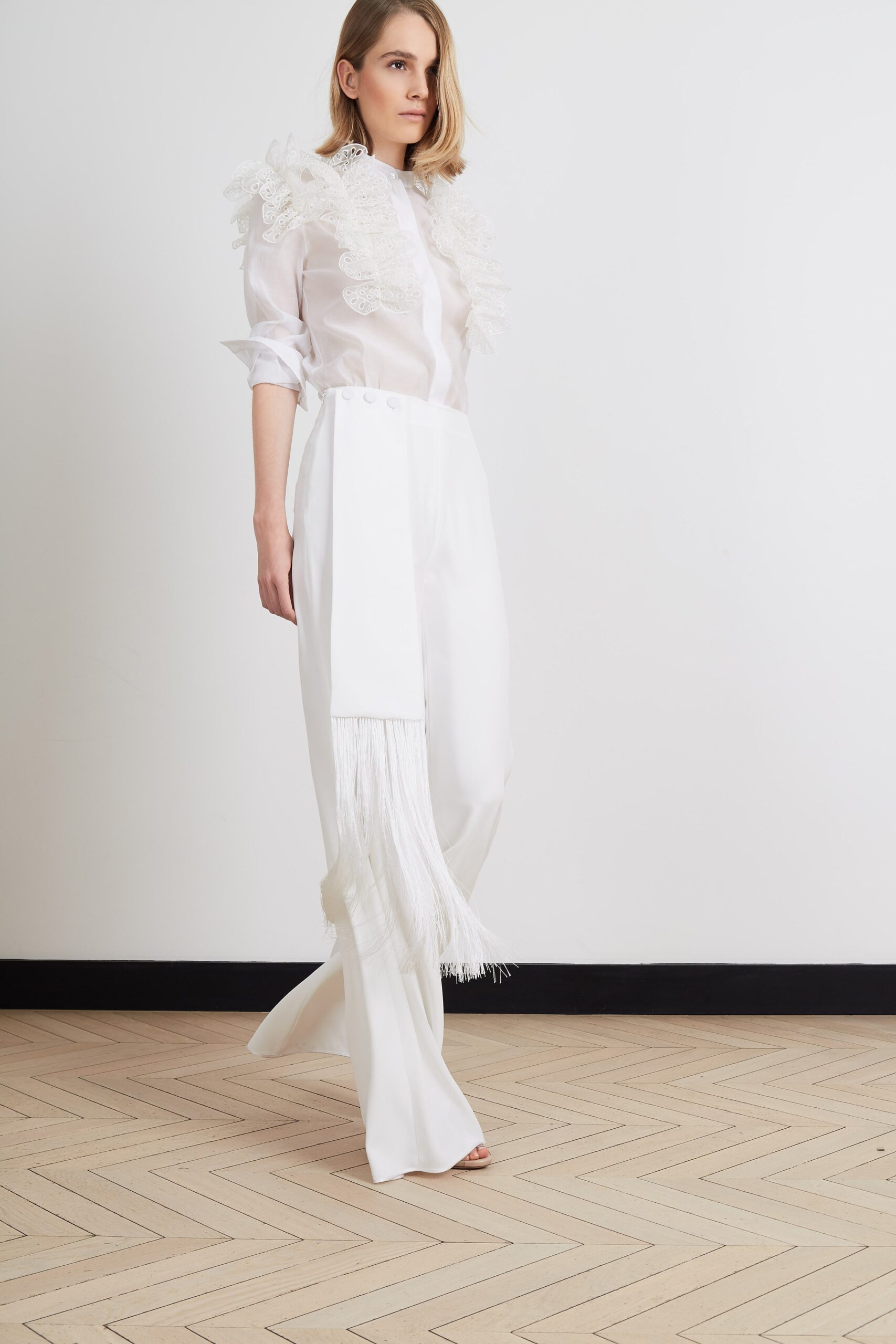 white ruffled blouse and wide-leg pants