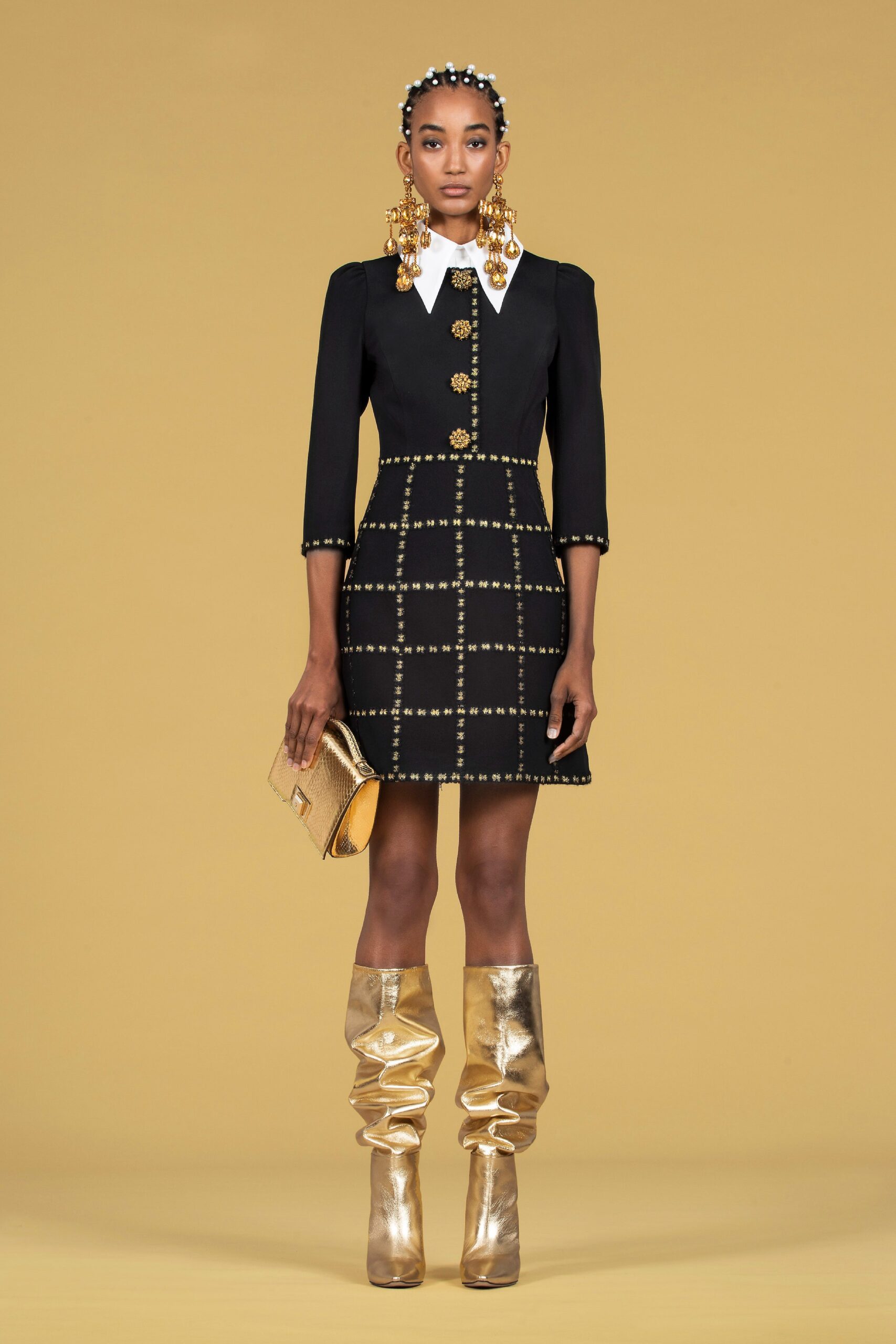 black fitted mini dress with gold accessories