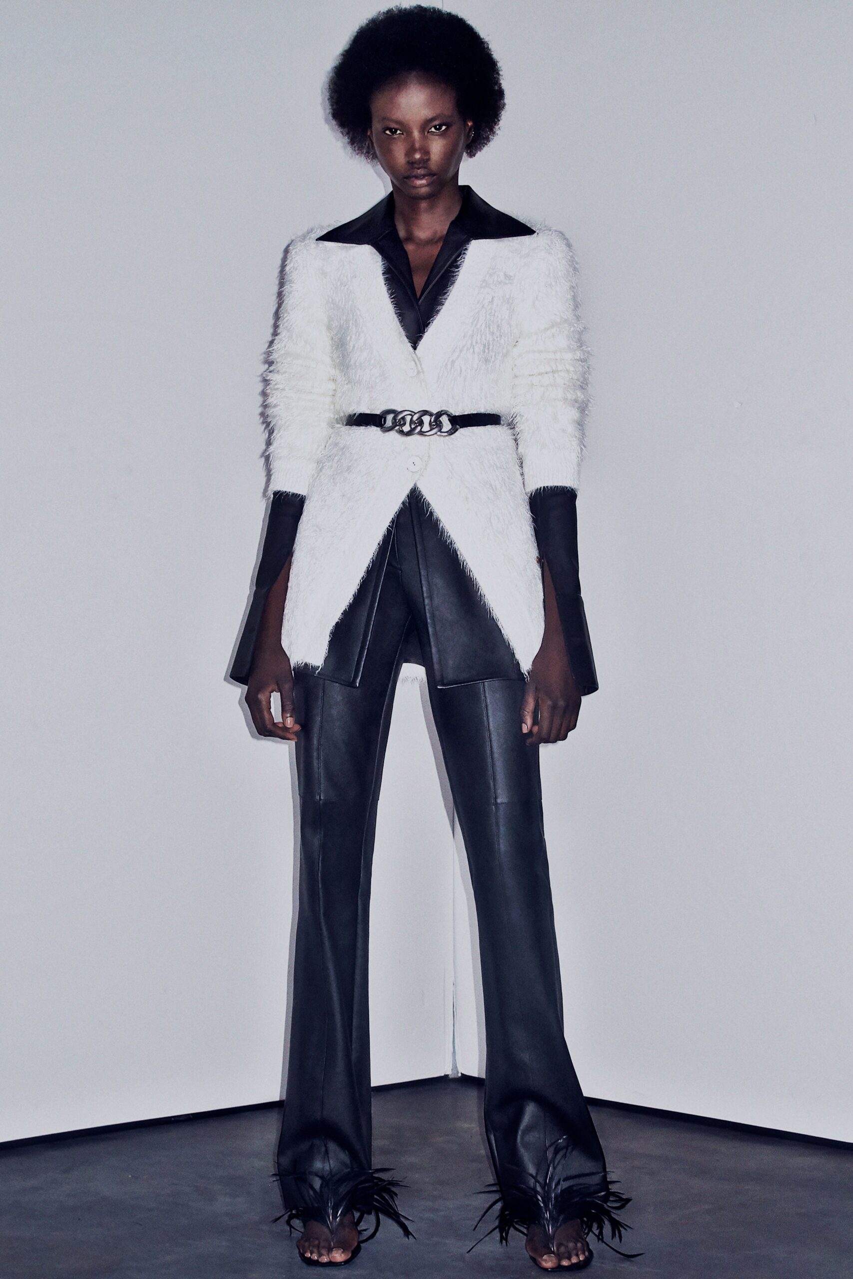 white fur tailored blazer with black leather pants