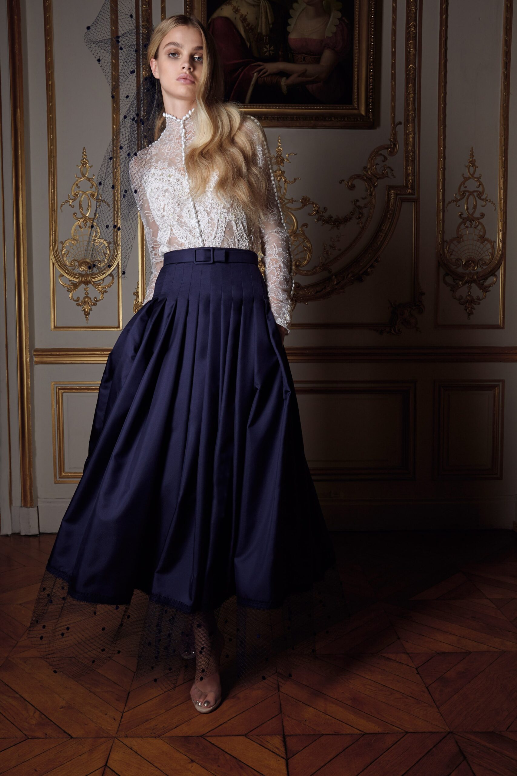 white lace blouse and navy pleated skirt