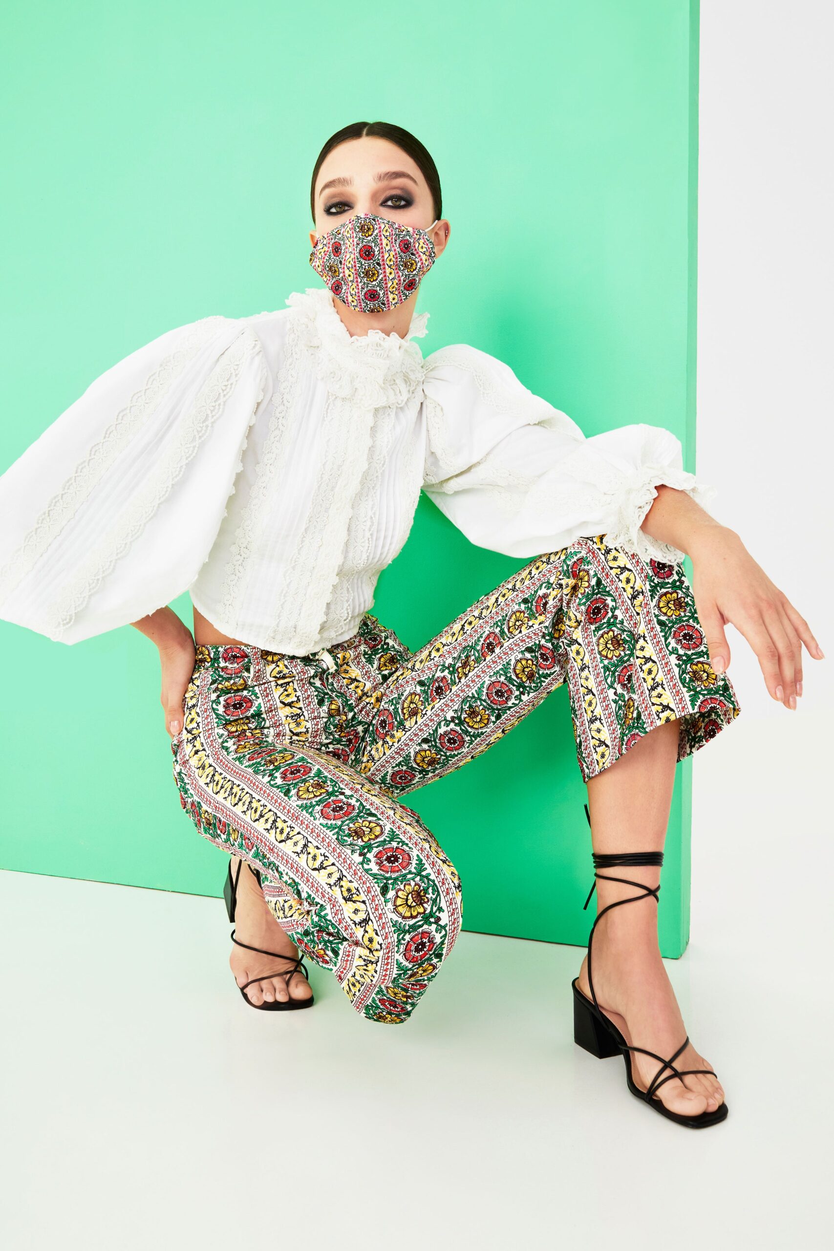 white ruffled blouse with printed pants