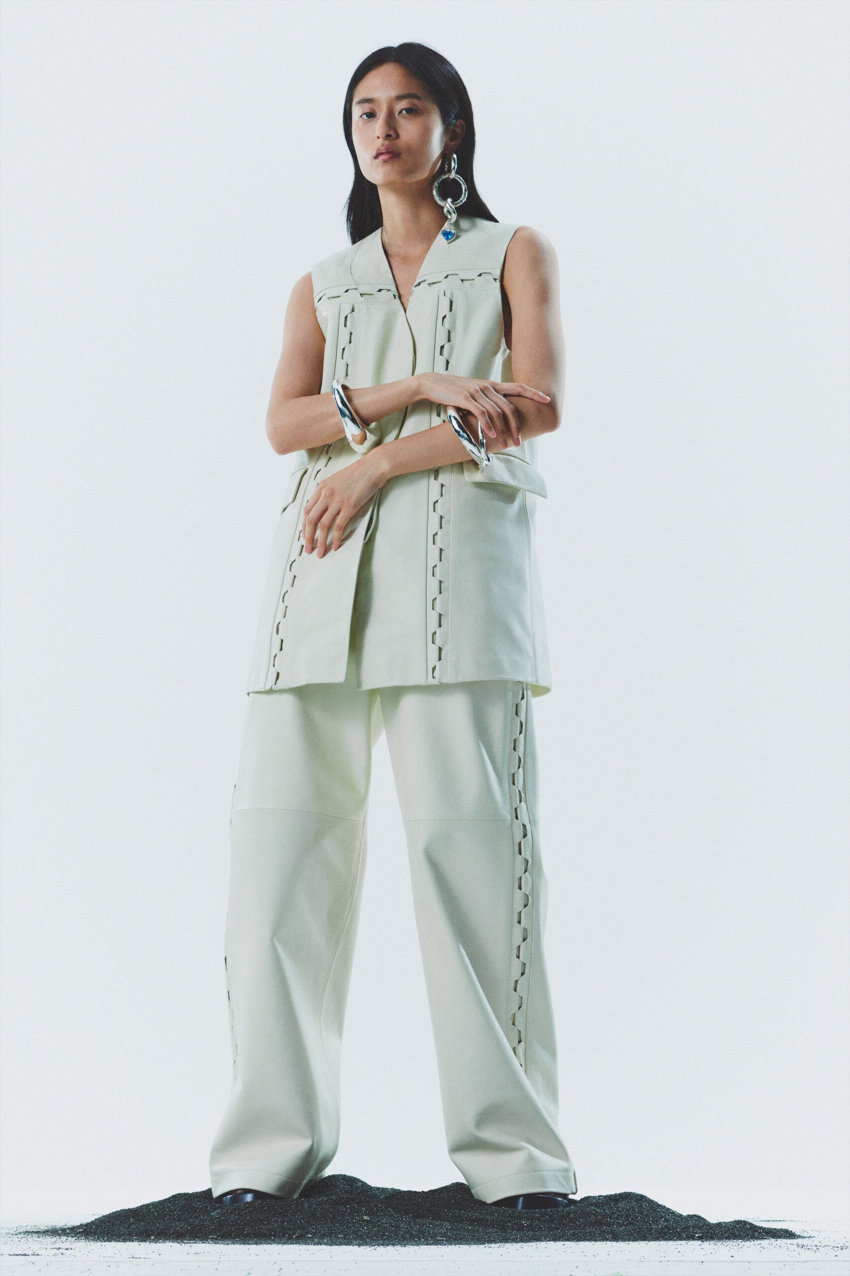 white leather sleeveless top and wide-leg pants