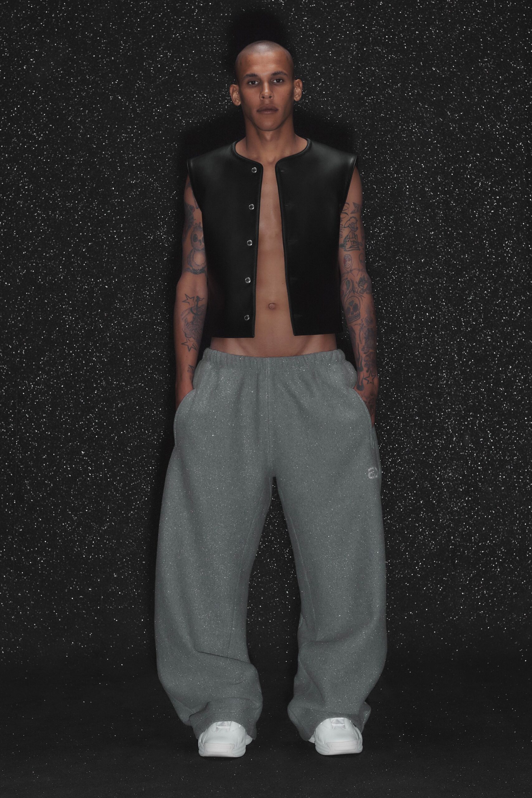 black vinyl vest and gray pants