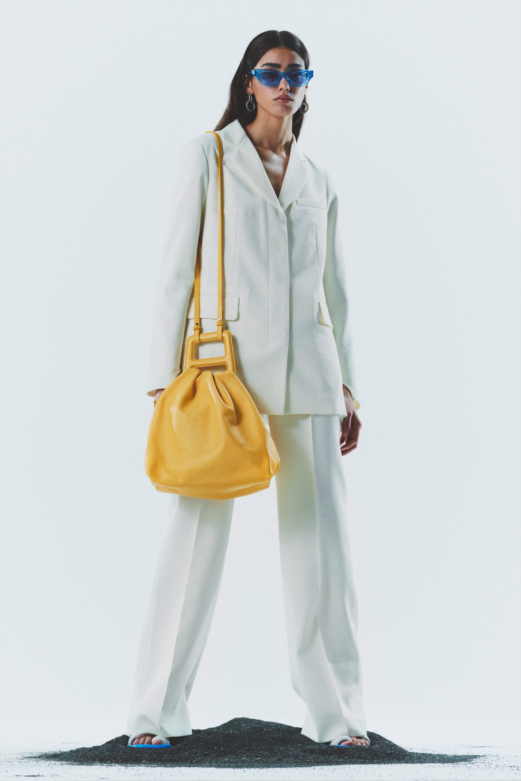 white tailored suit with yellow bag