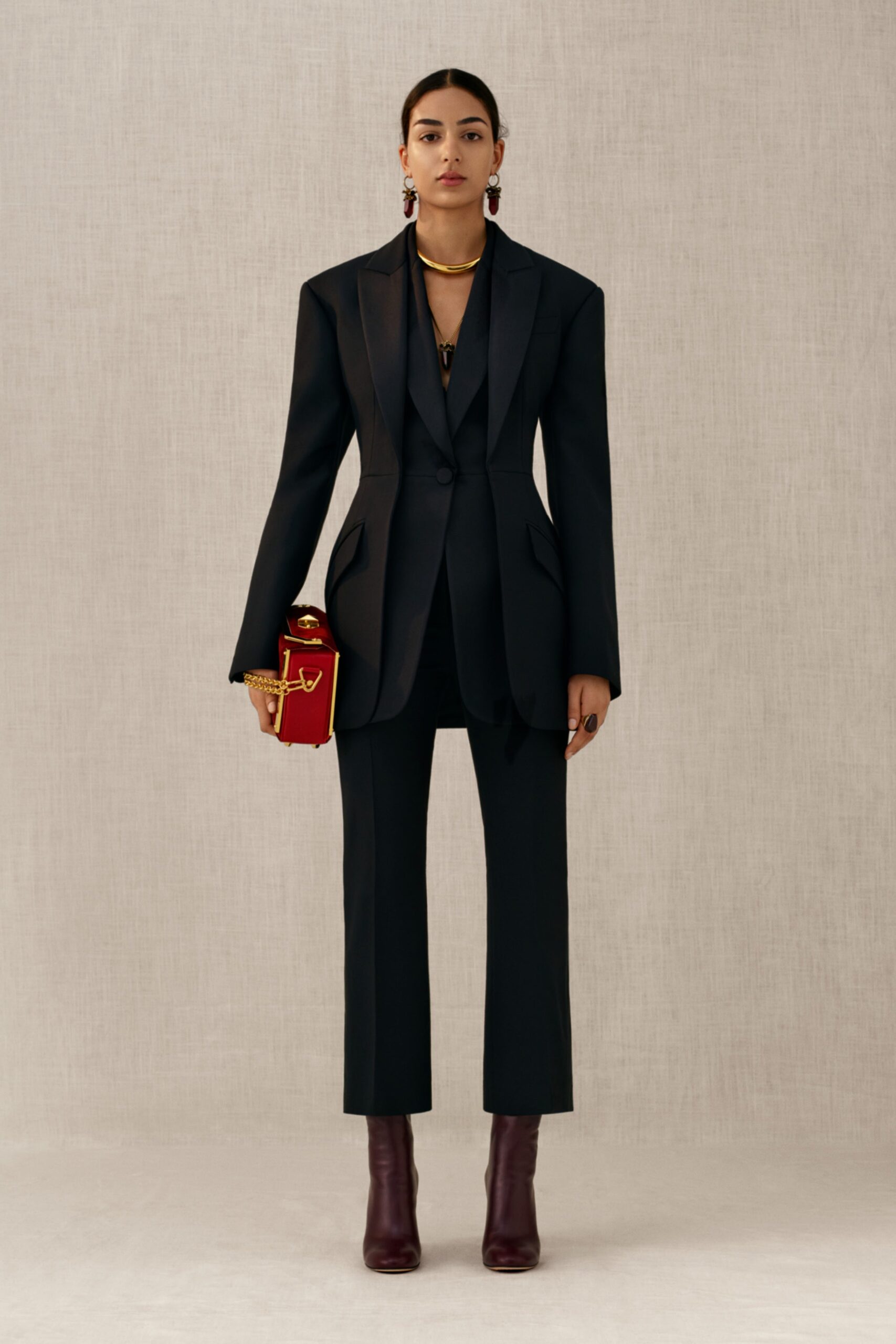black tailored suit with burgundy heels