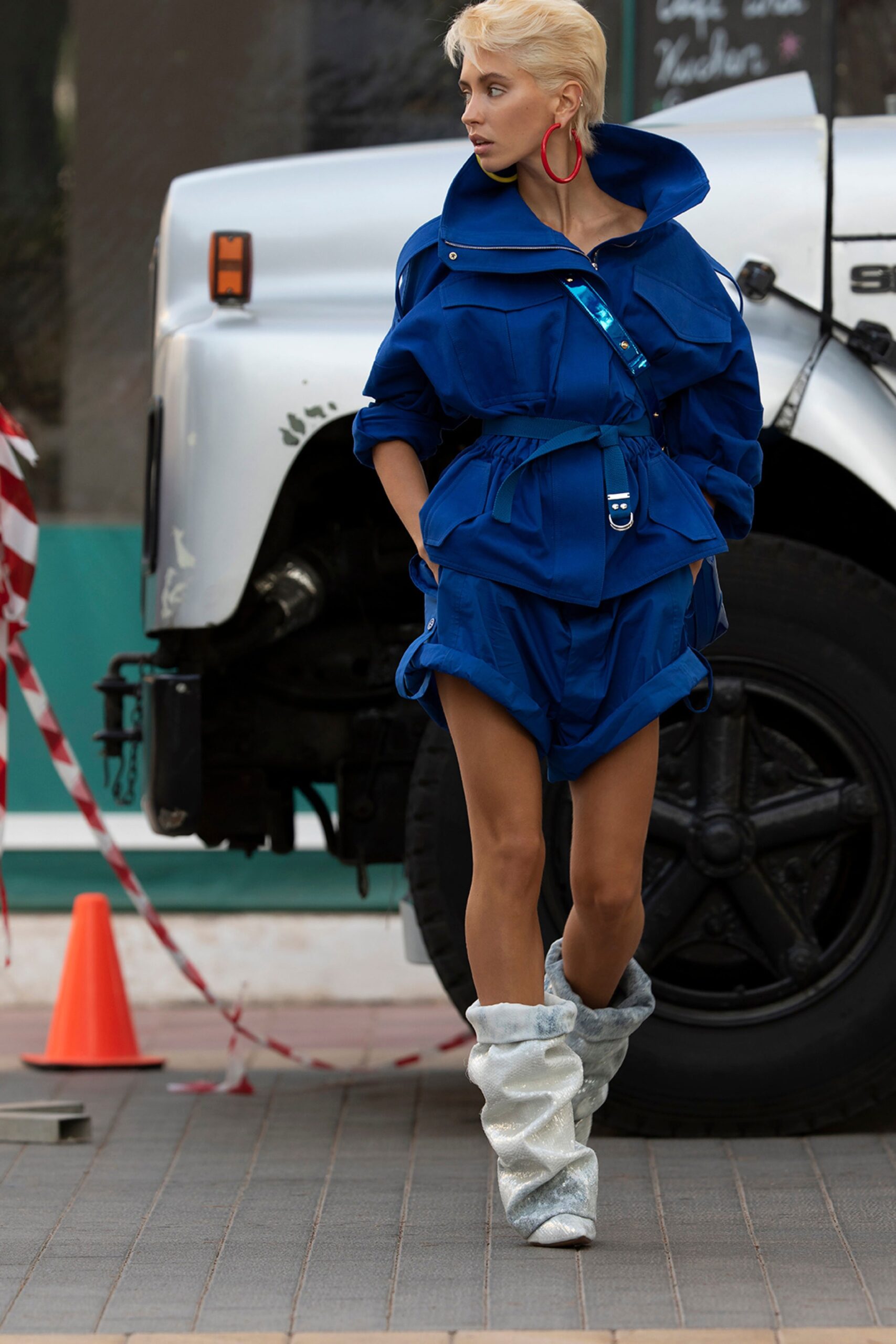 blue relaxed jumpsuit with silver boots