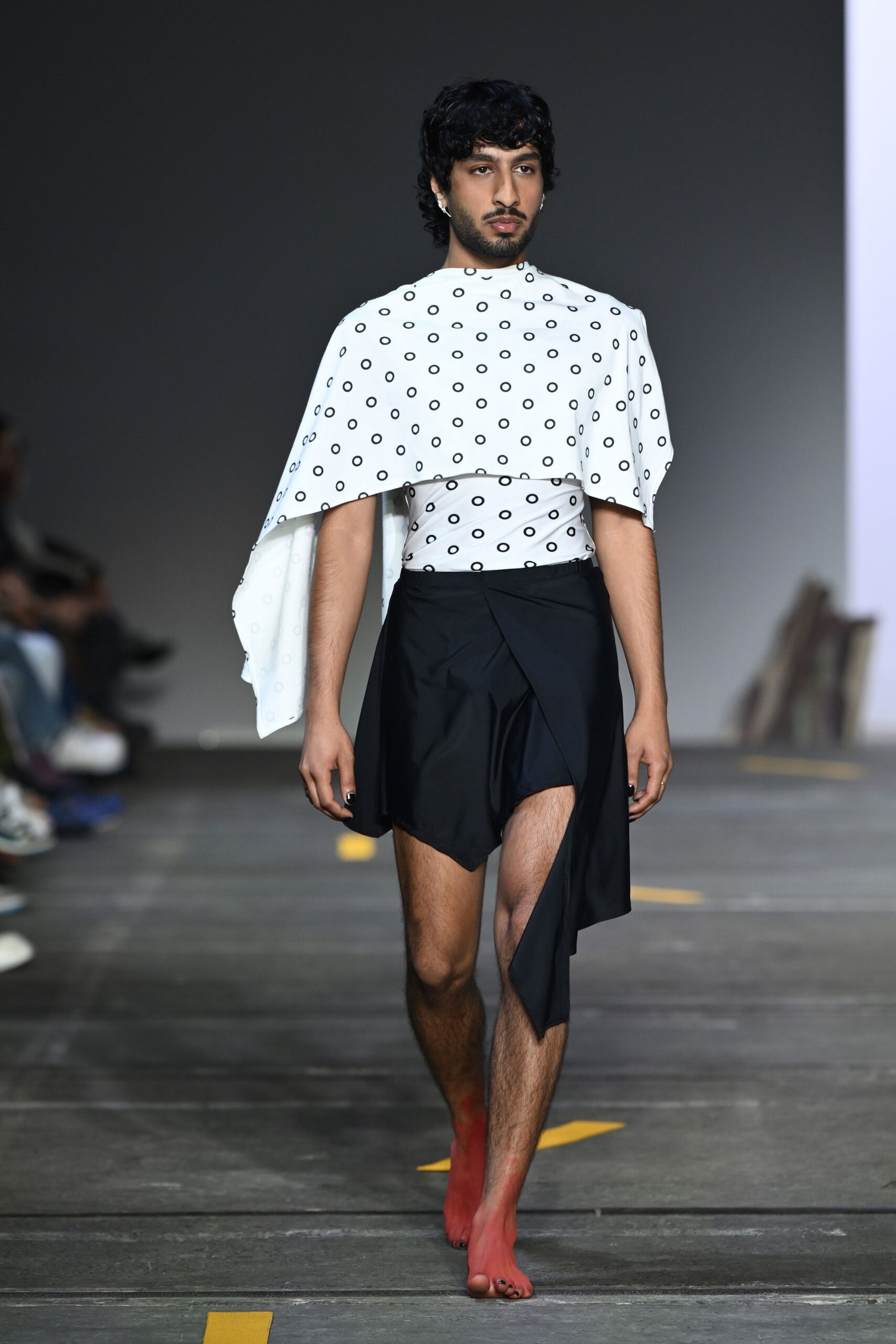 white printed sleeveless top and black asymmetric skirt