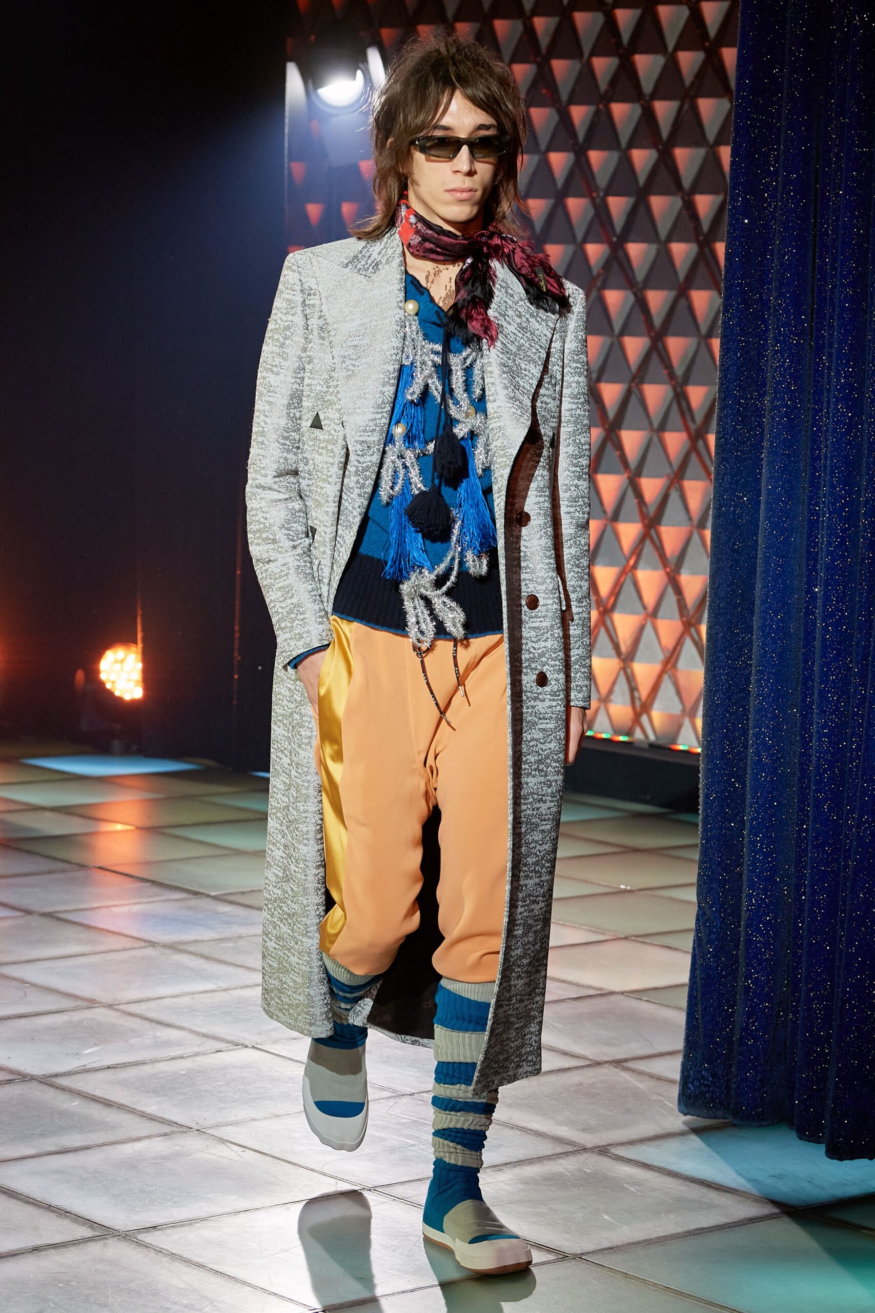 gray tailored coat with blue sweater