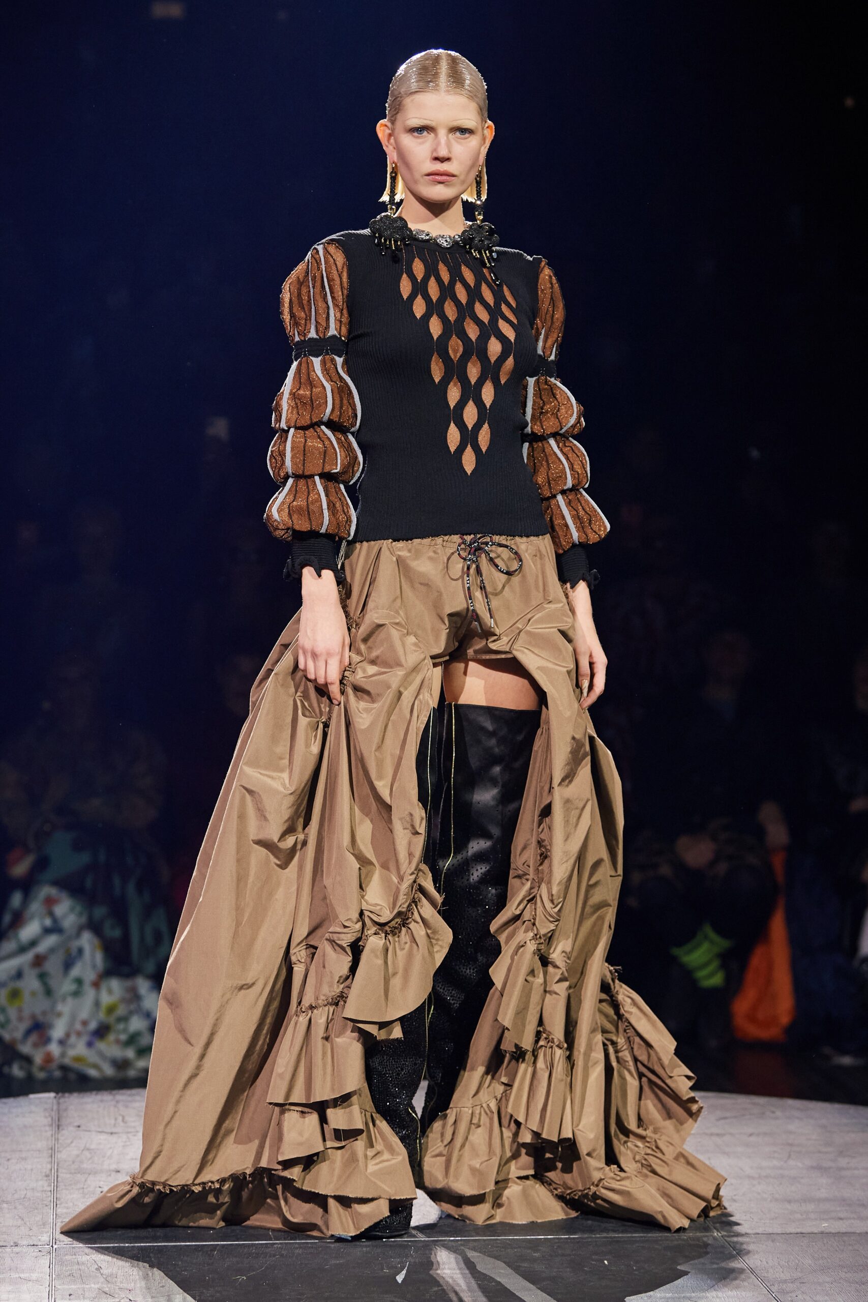 black fitted top with cutouts and brown ruffled skirt