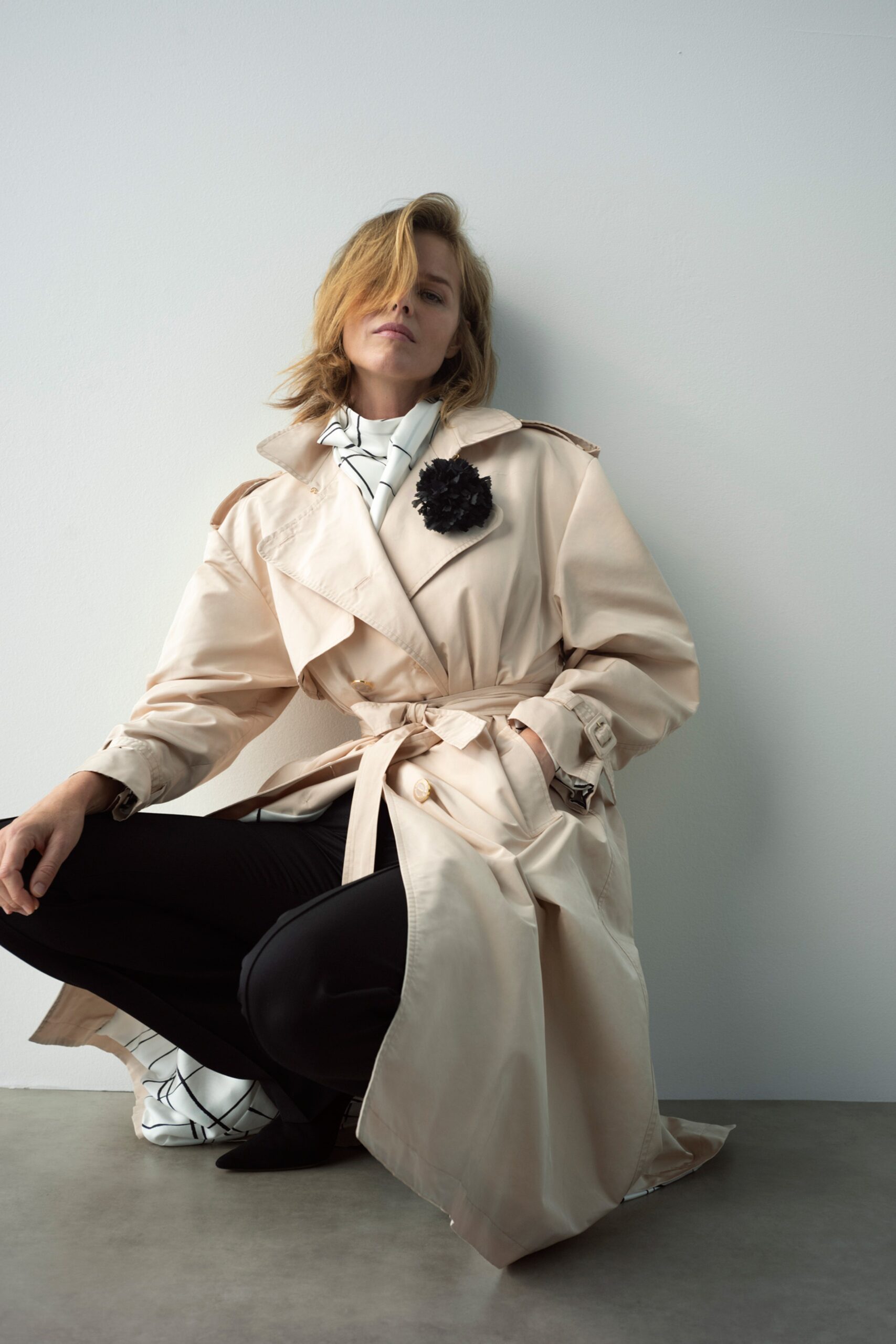 beige trench coat with printed blouse