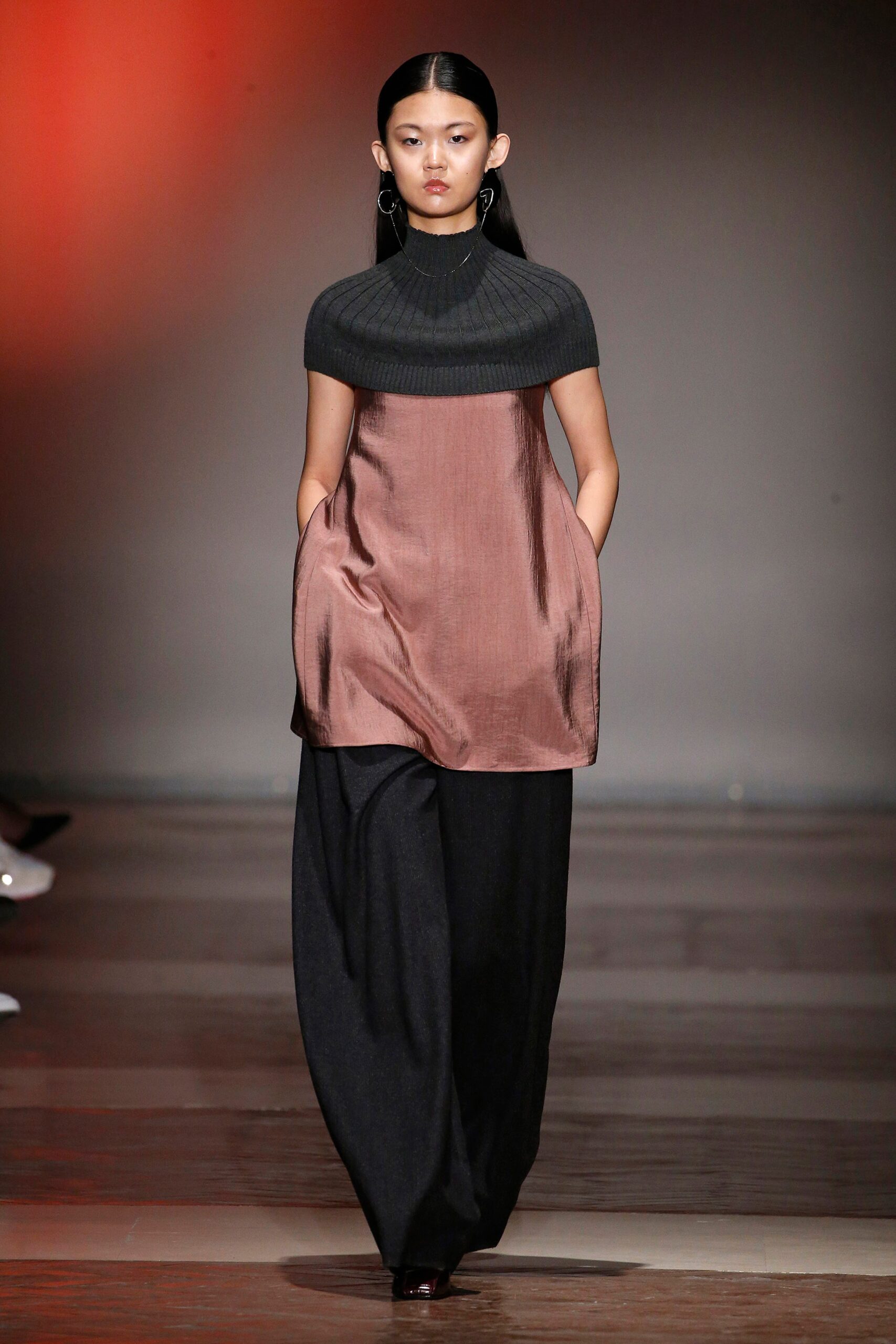 gray and brown layered top with black wide-leg pants