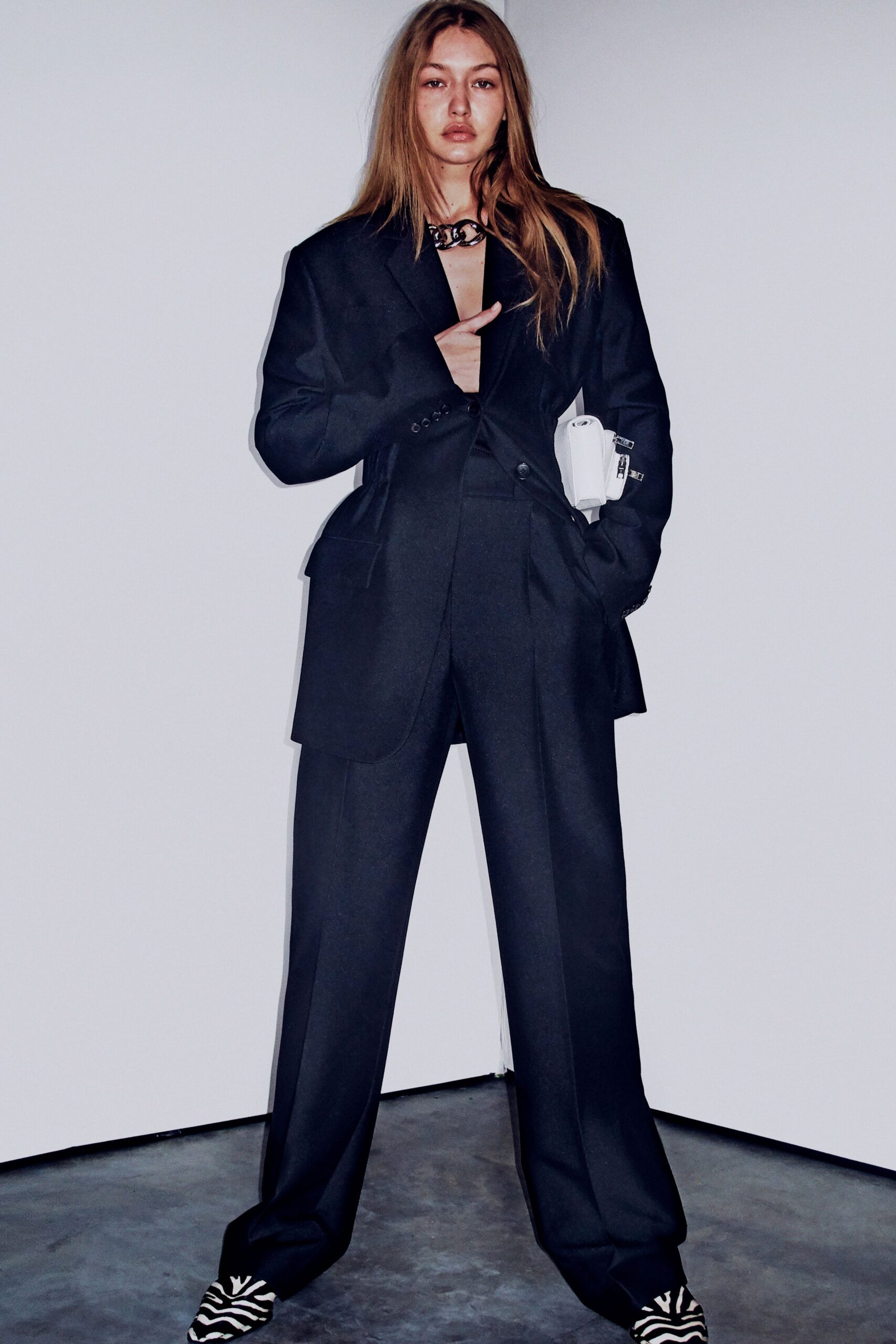 black tailored suit with striped shoes