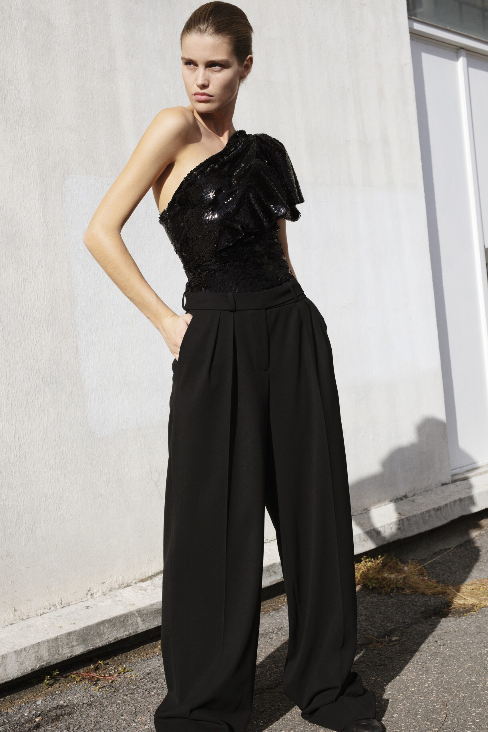 black sequin sleeveless asymmetric fitted ruffled shiny top