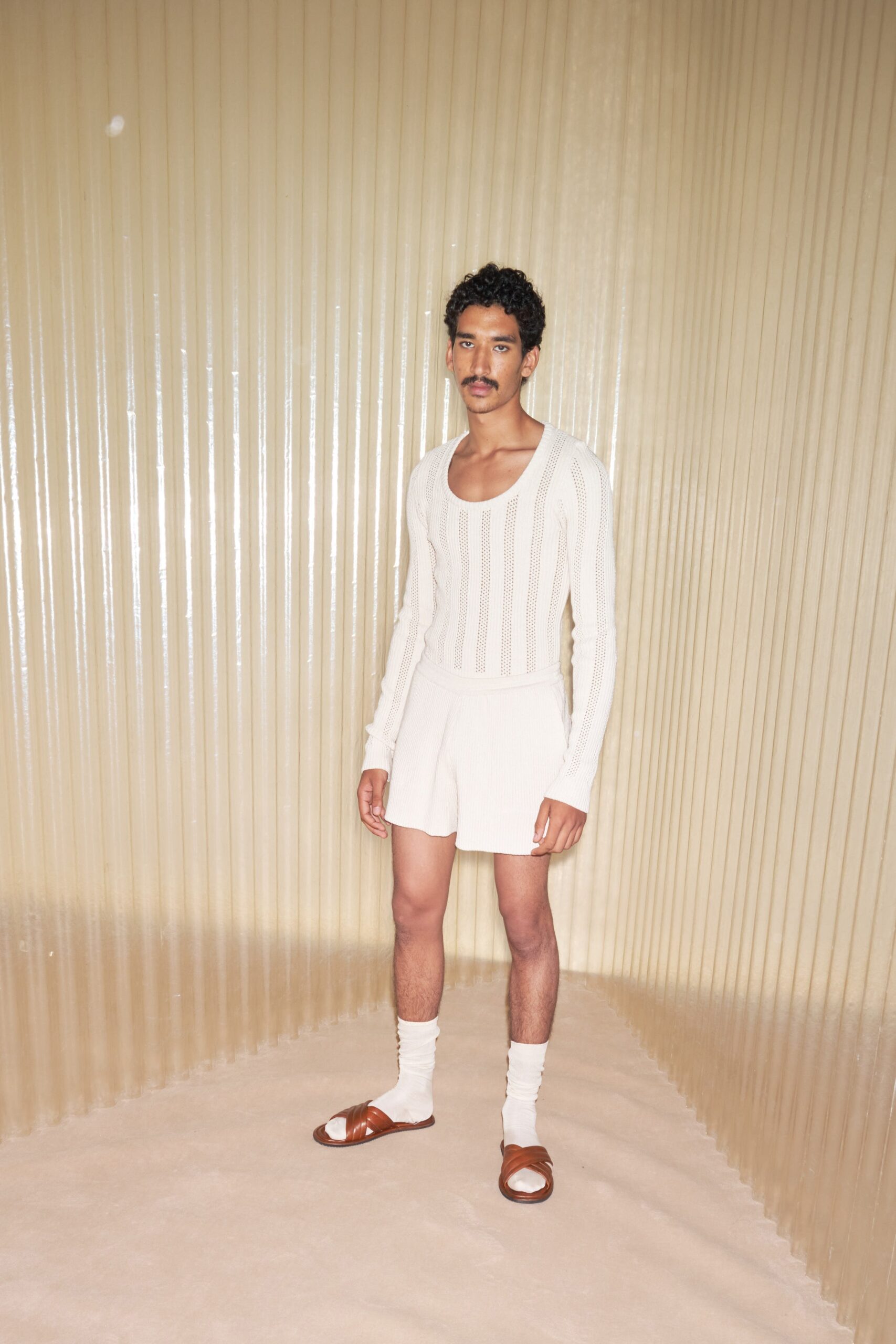 white fitted sweater and beige shorts