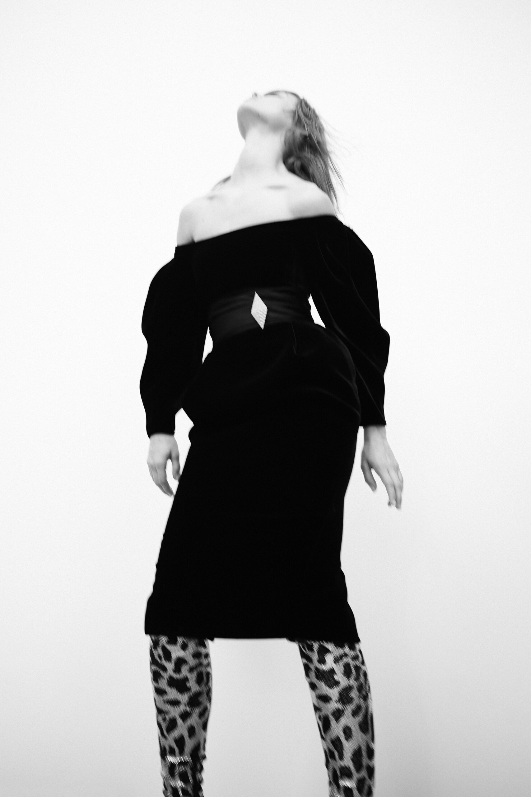 black velvet off-shoulder dress with animal-print pants